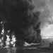 Oil burns on the waters of Pearl Harbor, near the naval air stat