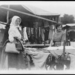 Woman shopping for textiles at market, Hungary 1923