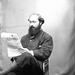 Ambrose Congreve reading a newspaper at Clonbrock House