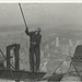 Construction-worker-standing-on-an-I-beam-pulling-a-rope-1931-52