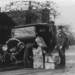 Policeman and wrecked car and cases of moonshine