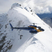 an alpine heliski ltd chopper sits atop temple pea